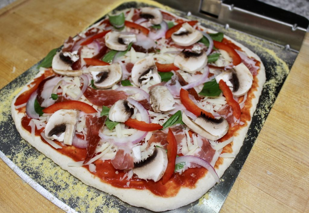 homemade pizza on bakerstone pizza oven for barbecue